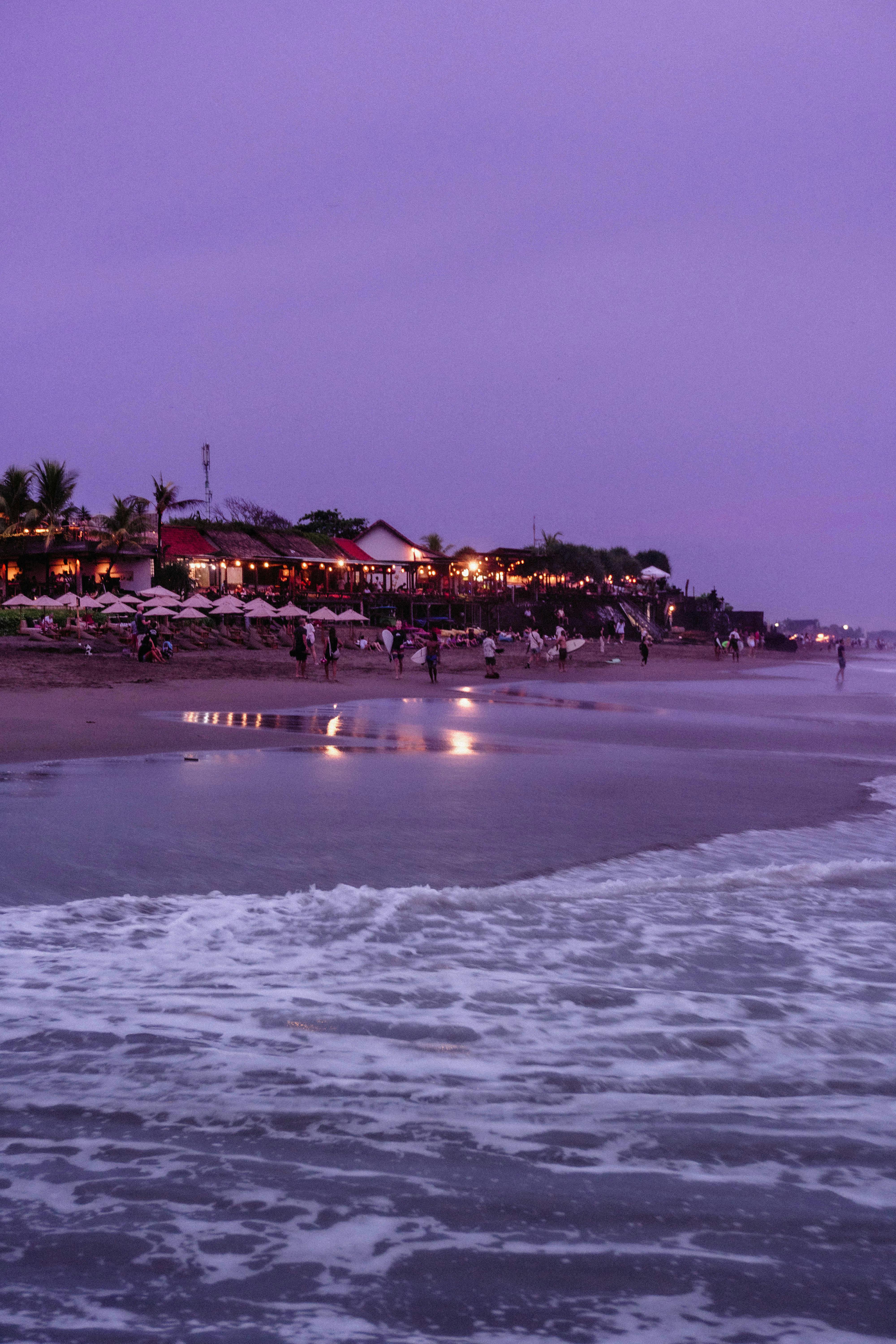 Pristine golden beach with turquoise waves at Seminyak during sunset
